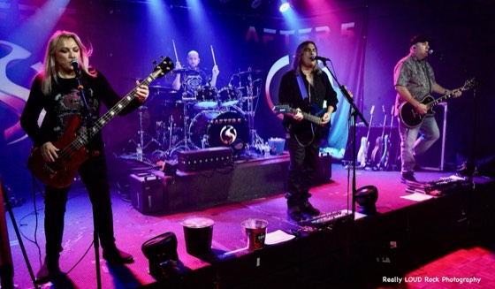 The full After 5 line-up on stage under pink and blue lights