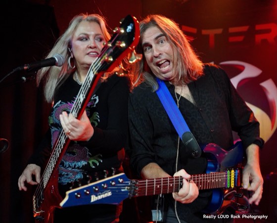 Two members of After 5 sharing a microphone